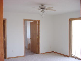 Master suite view to walk-in closet and bathroom
